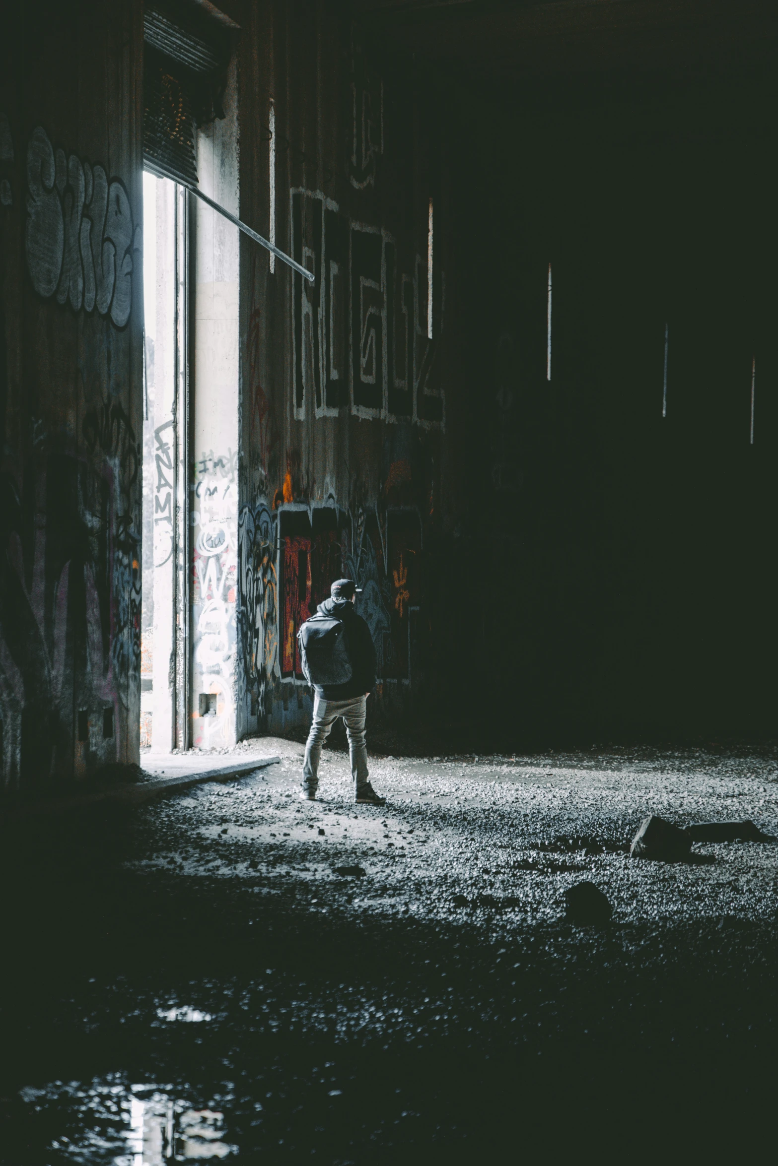 a person walking with their backpack towards a doorway