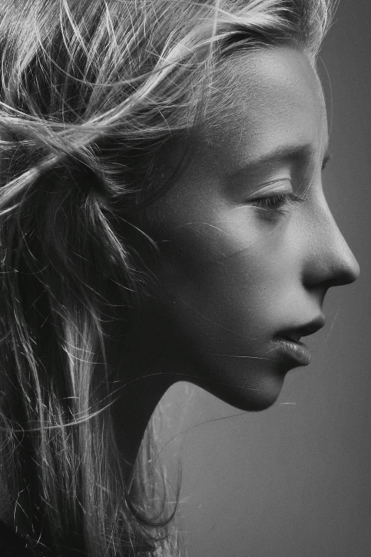 the profile of a woman with blonde hair is shown in black and white