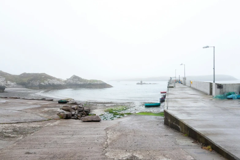 the dock on the beach is deserted by the water