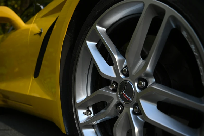 a wheel of a yellow sports car