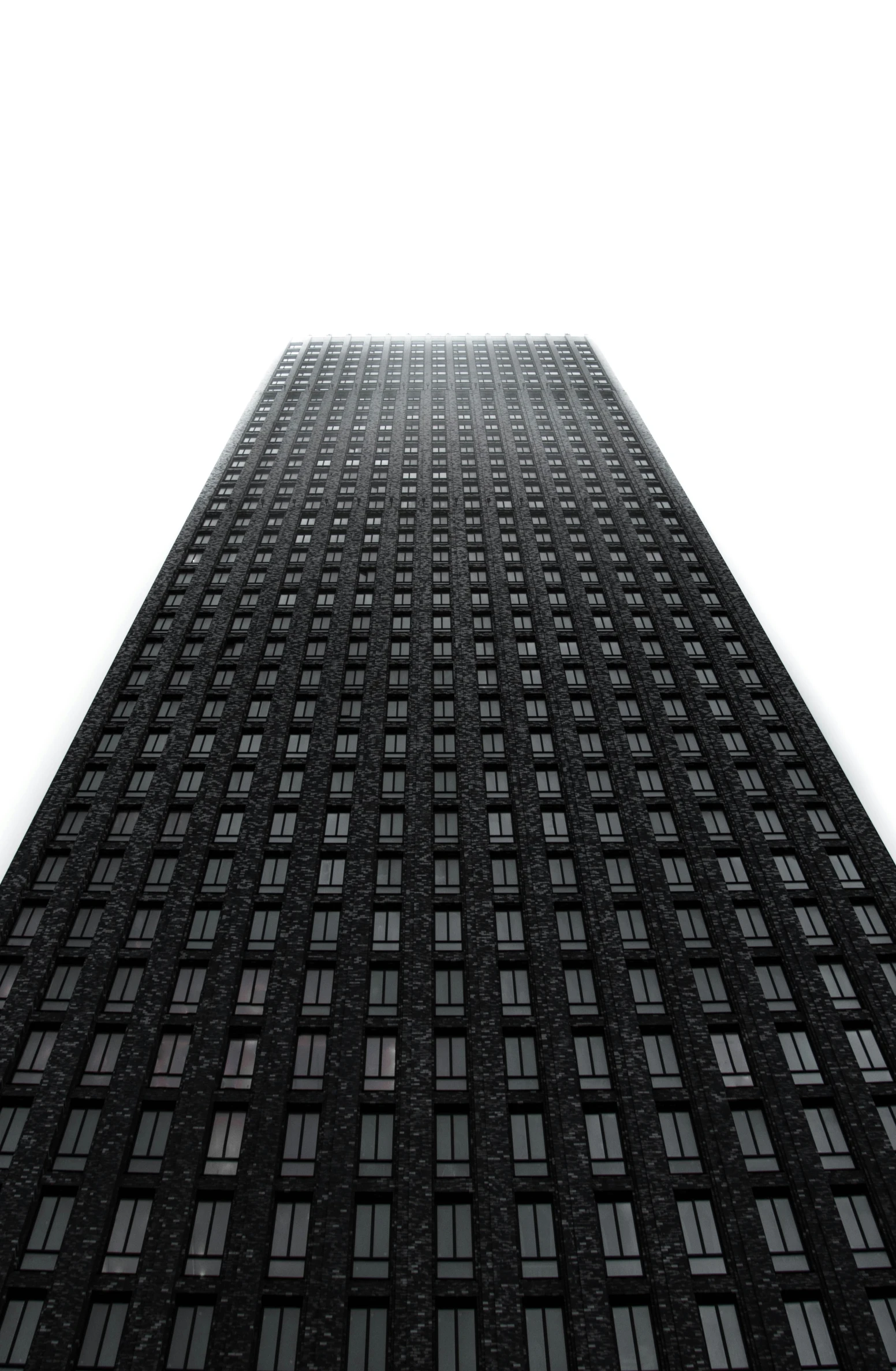 looking up at the top of a large black building