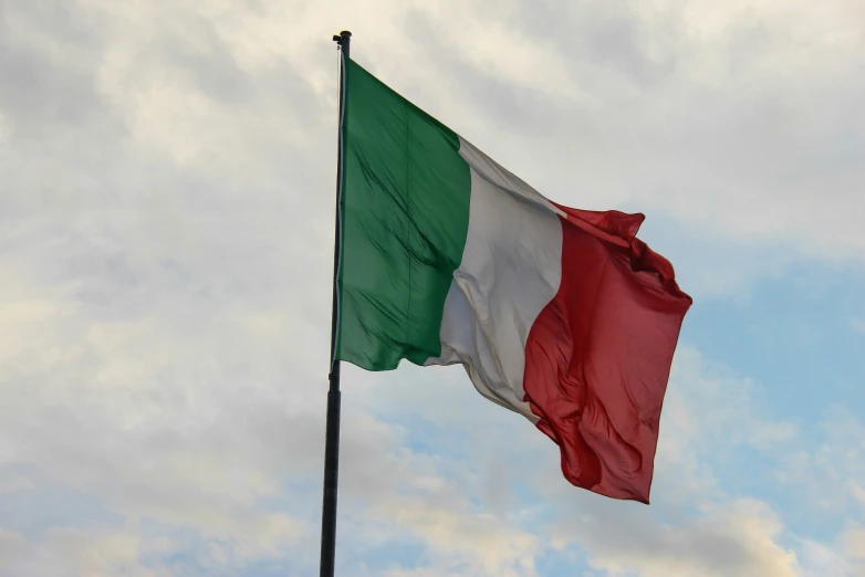 a very large italian flag flying in the air