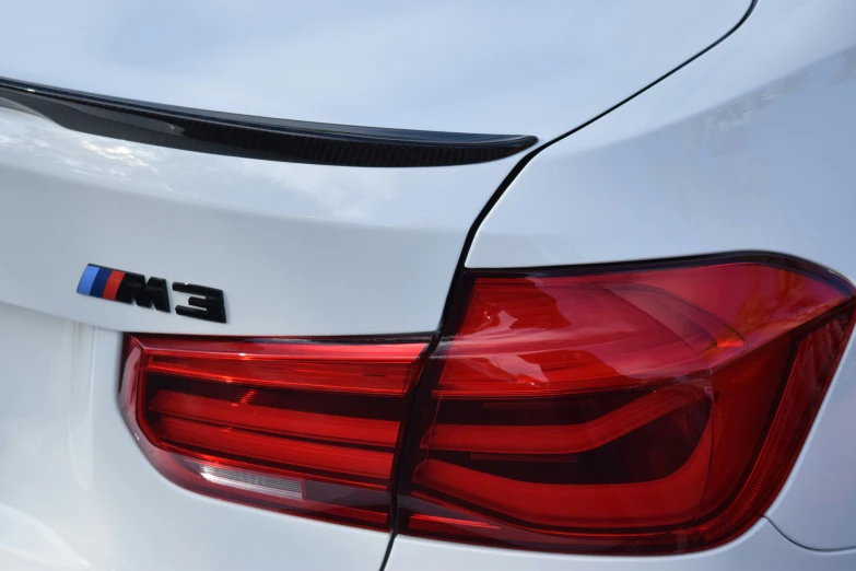 the rear end of an white bmw car