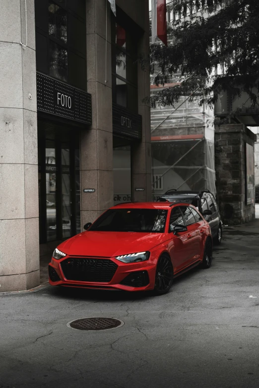 a red car is parked in the middle of a street