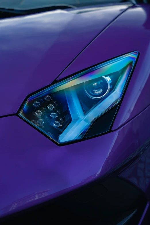 a closeup of a purple sports car's front view mirror