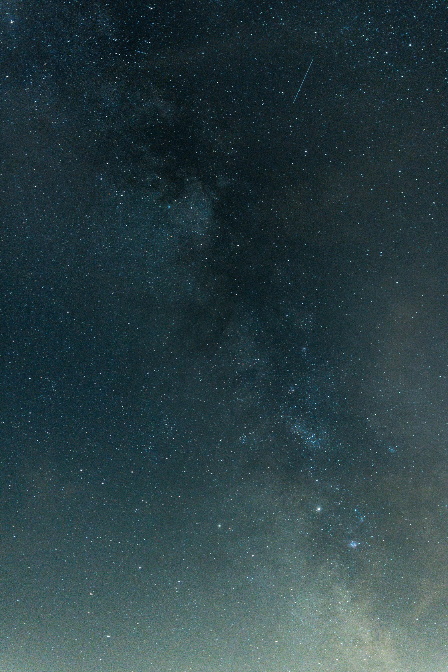 the view of the night sky from a hill