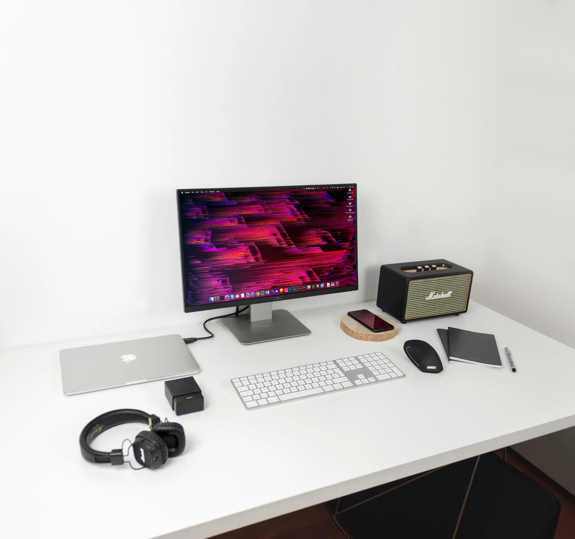 there are computers on the desk with earphones