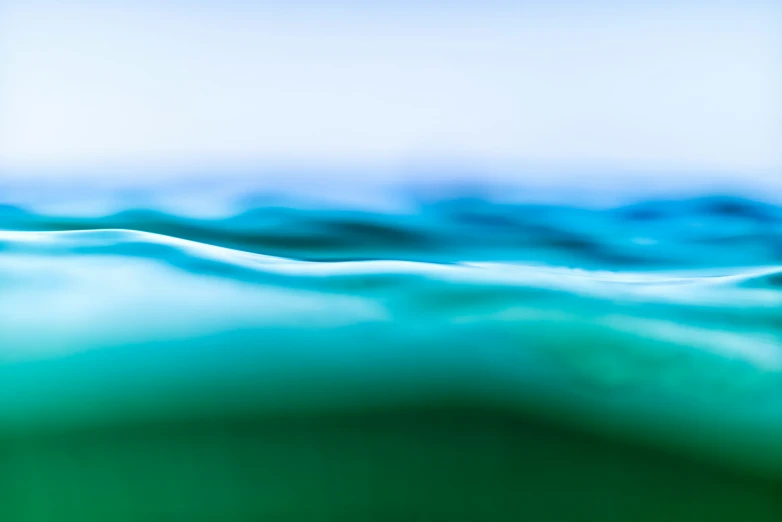 an abstract blurry picture of blue and white waves