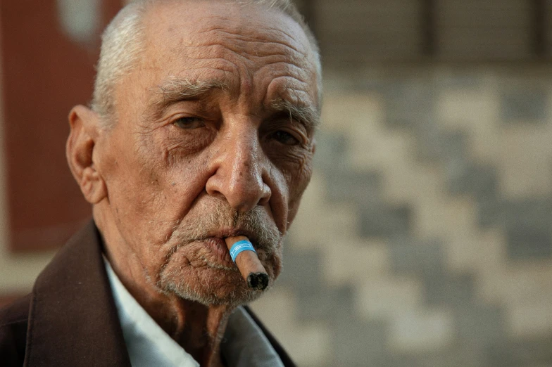 an old man with a pipe in his mouth