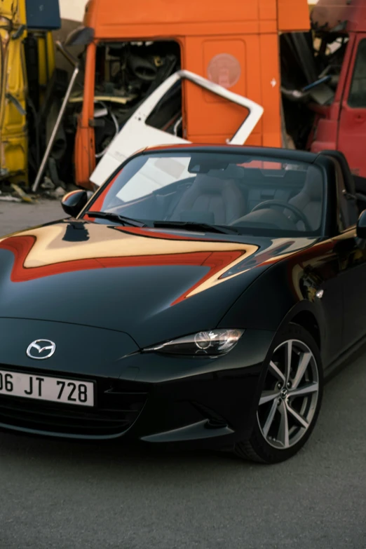 a sports car parked in front of a truck