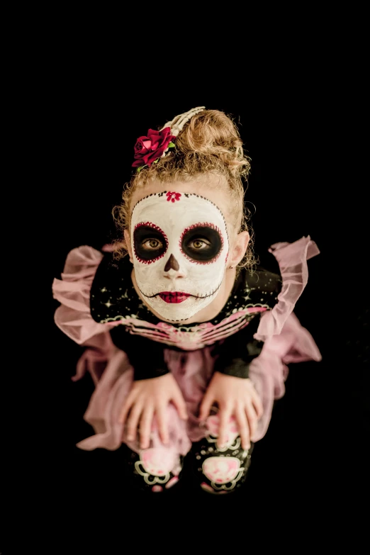 a woman with a skull face painted on her