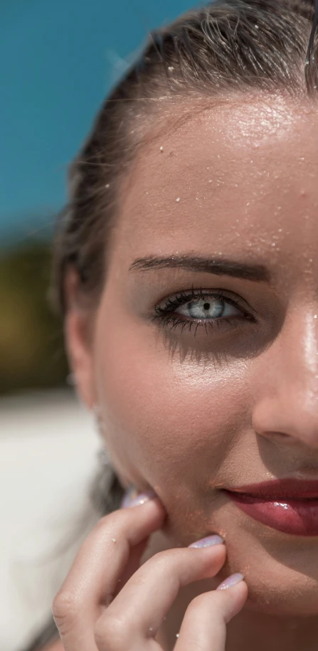 a woman with a black top and a bright makeup has a slight face