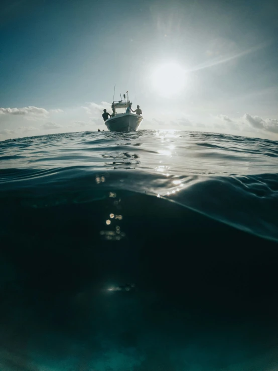 an ocean with a boat out on the water at sunset