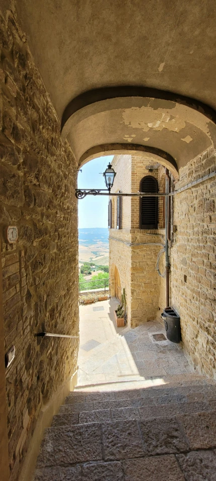 an arched passageway leading up to a wine cellar