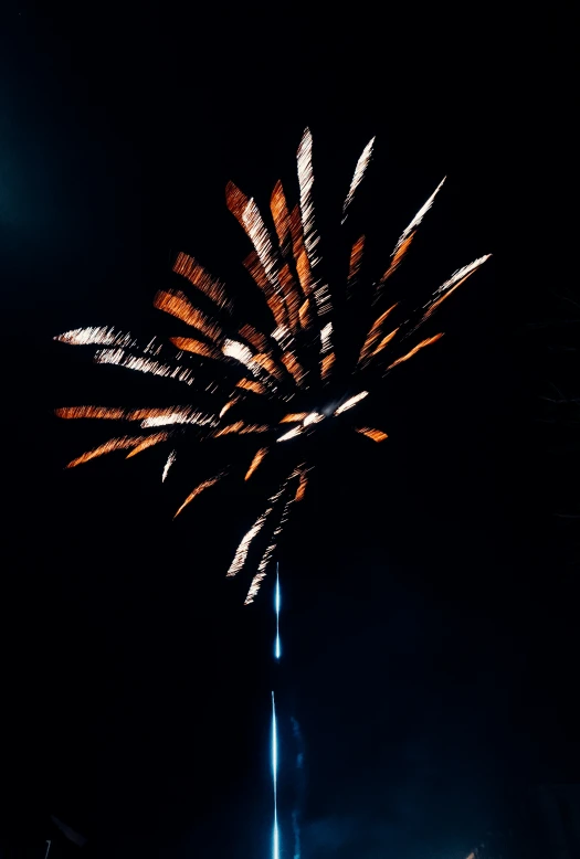 a blue, yellow and white fireworks on a pole