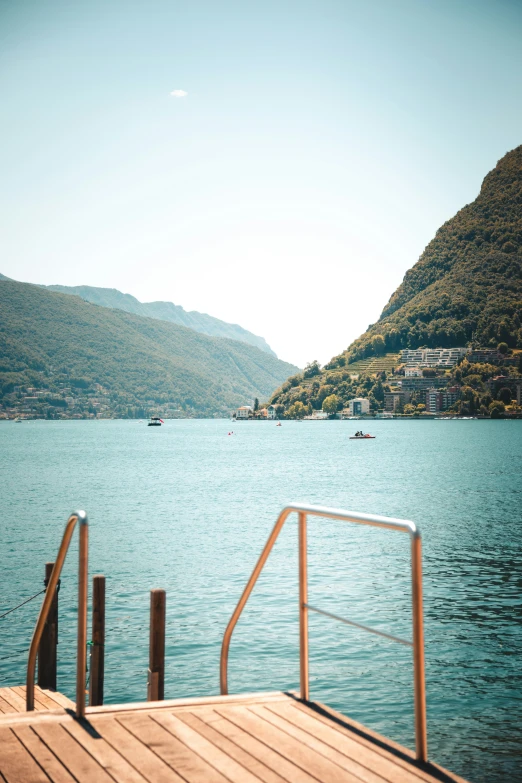 a view of some calm water near mountains