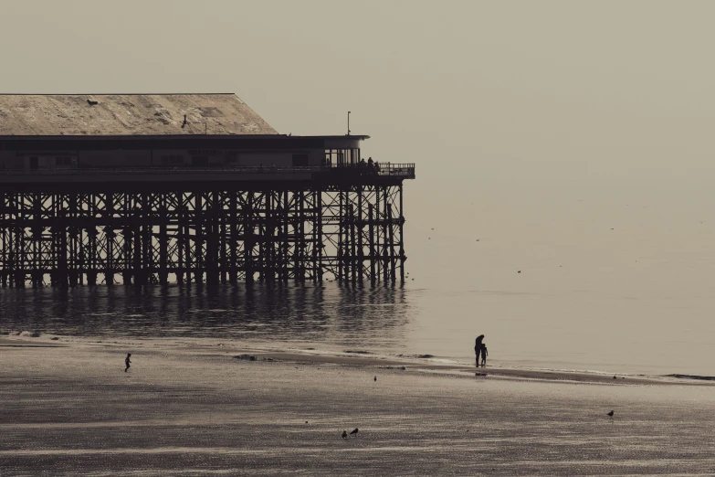 a pier is shown on a foggy day near the water