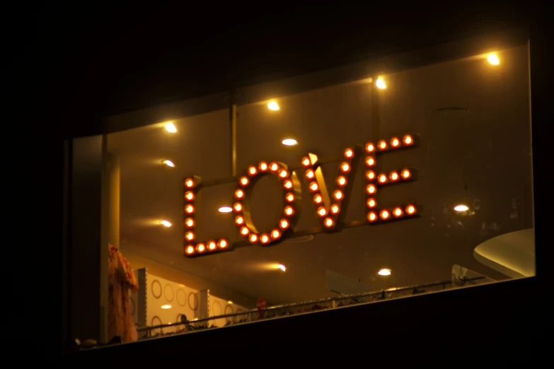 a lighted love sign with some lights on