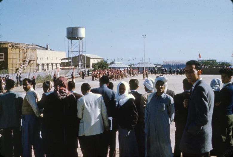 a group of people with headscarves in front of water tank