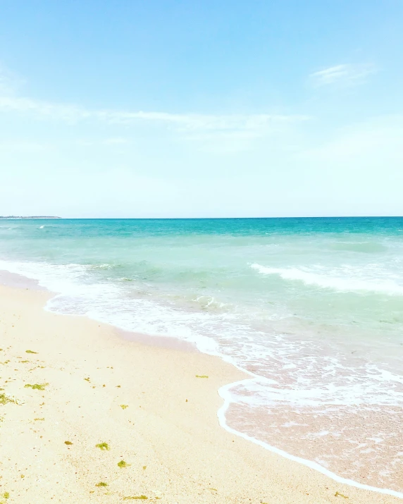 the sand and water of an ocean shore