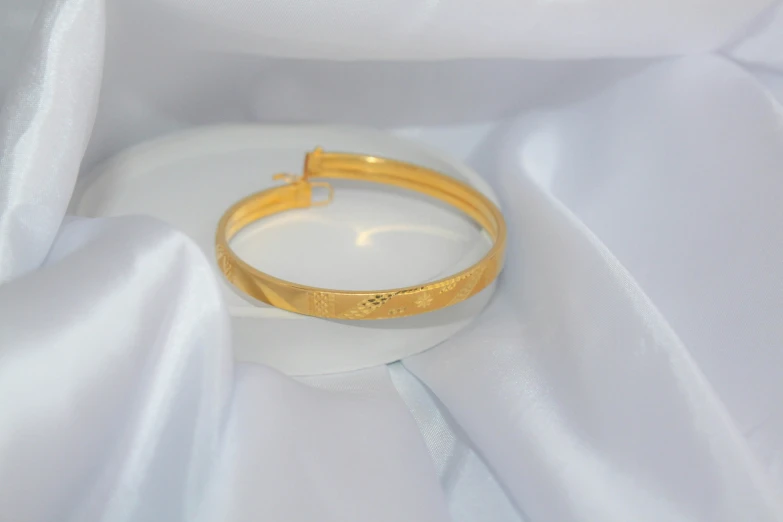 an image of a gold wedding ring in a fabric