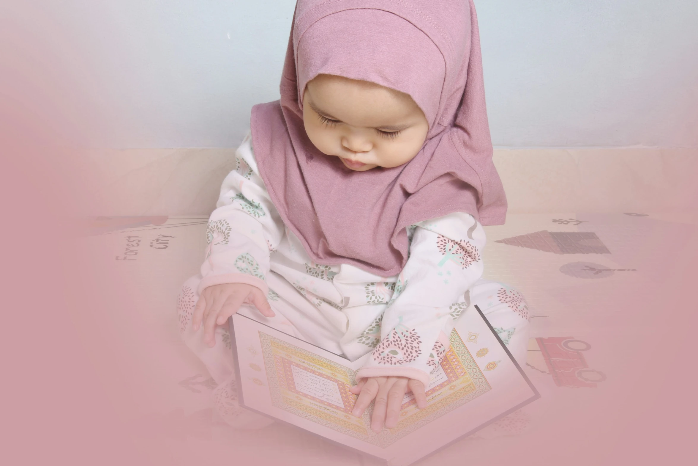 a baby sitting on the floor with a towel wrapped around her head