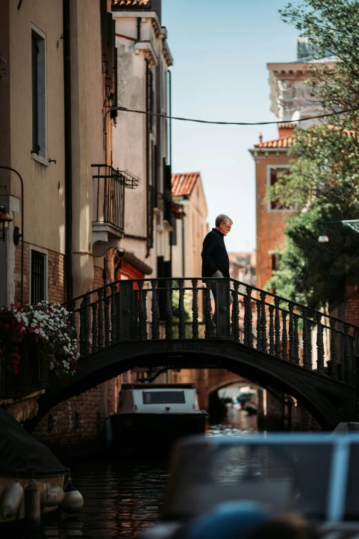 a man that is standing on a bridge over water