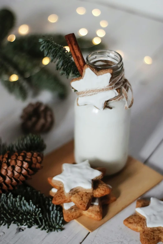 christmas cookies and milk are laying next to a bottle