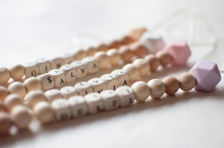 some wooden beads that spell out the word gilya