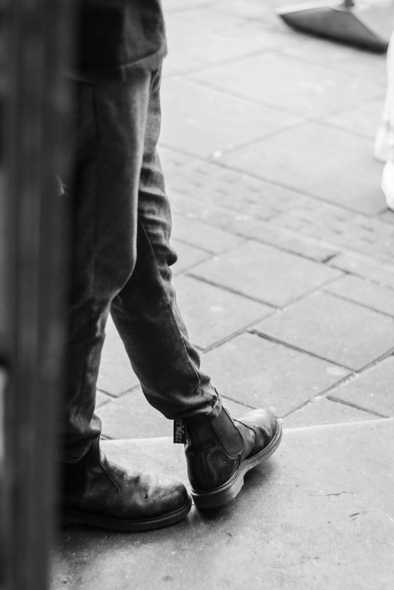 someone is standing on their shoes near the water