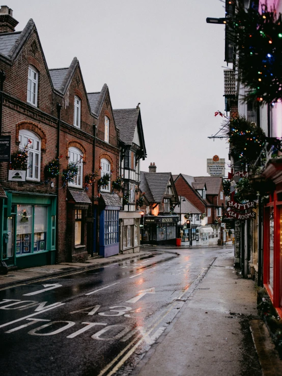 a wet street that has lots of buildings on it