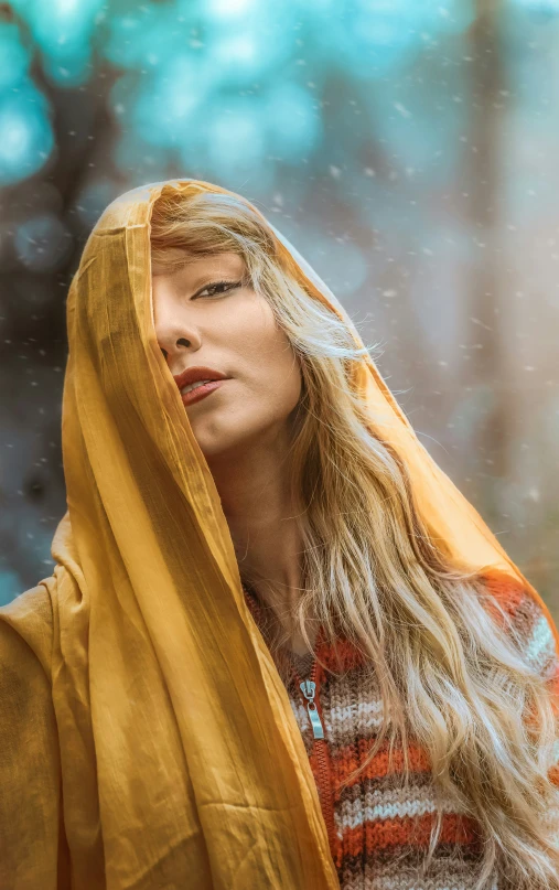 a woman in yellow shawl walking through snow