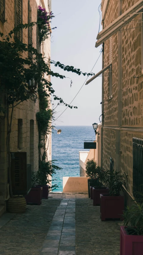 an alley leading to the beach in an old part of town