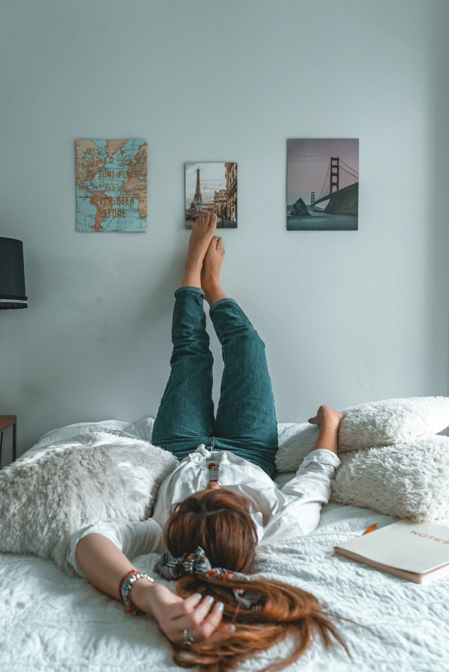 a woman lays on her back on a bed