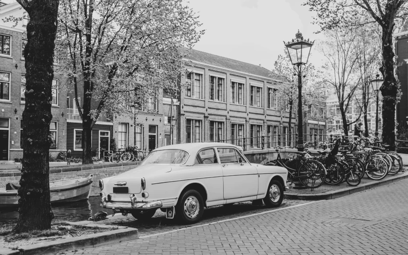 black and white pograph of cars parked in front of buildings