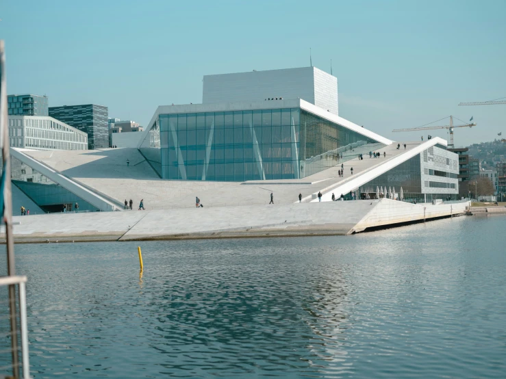 a building with many windows and some buildings near water