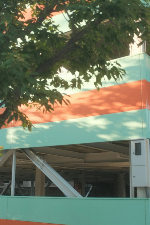 a colorful building that is under a tree