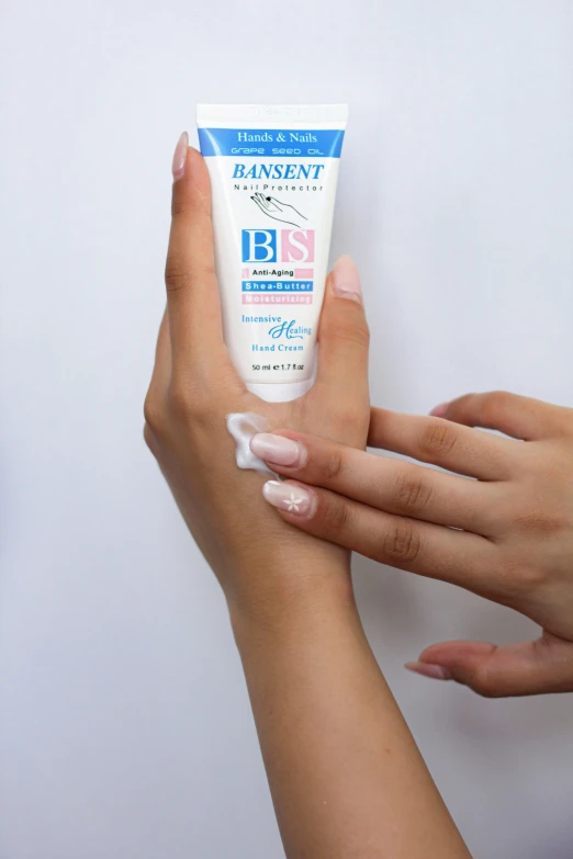 two hands holding an open tube of moisturizing gel