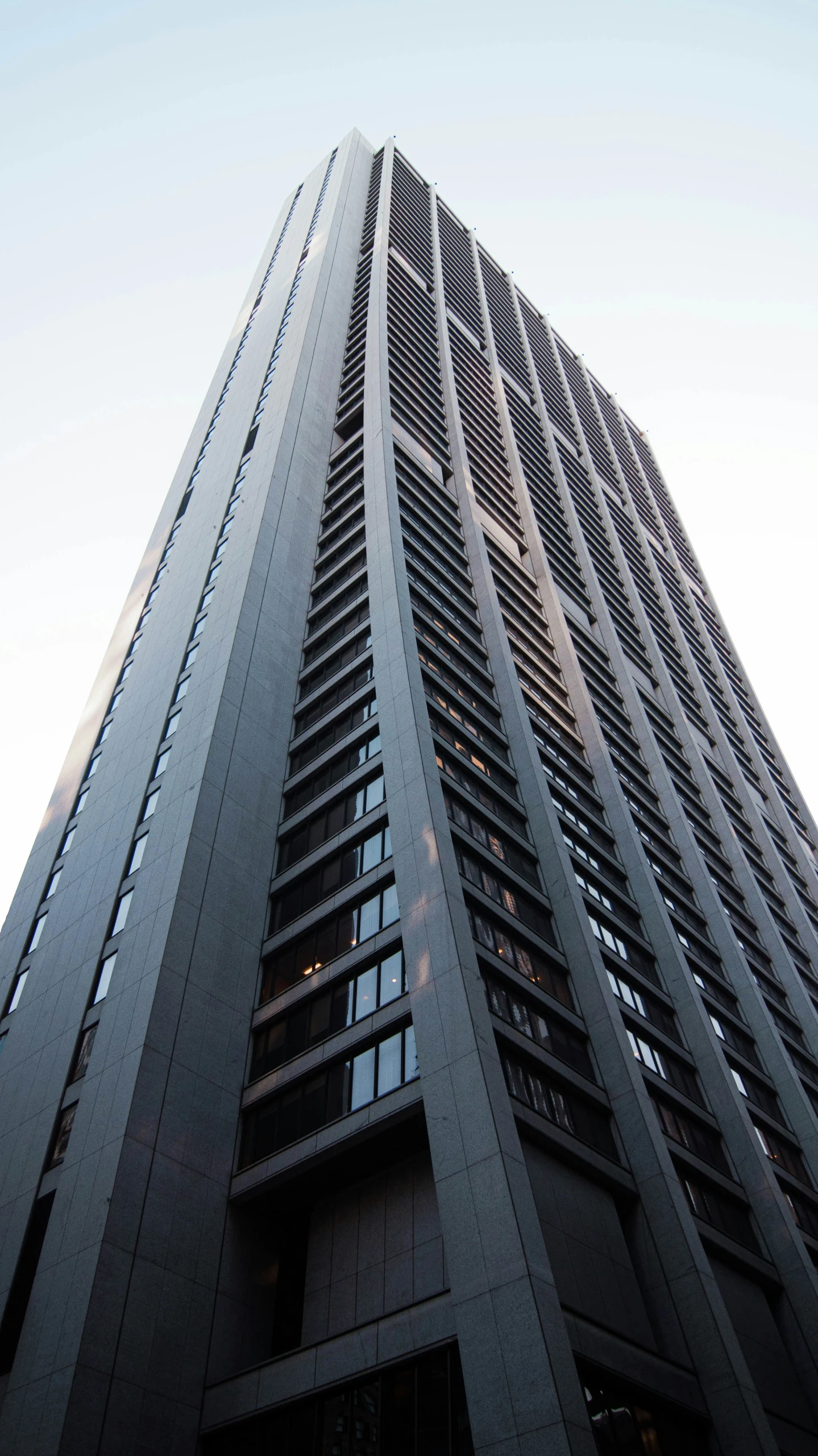 tall building with black metal mesh at the top