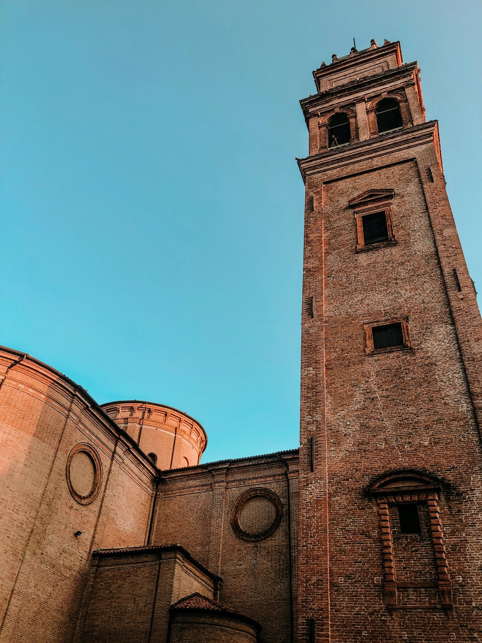 a large brick tower against a blue sky