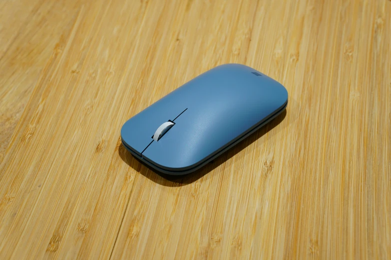 a wooden surface with a blue mouse on it