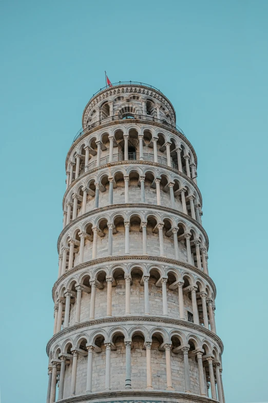 a very tall tower with a red flag on it