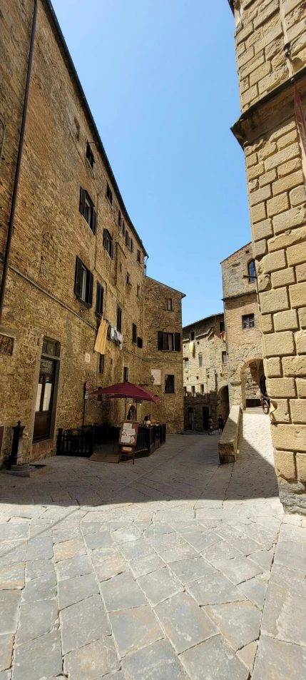 an outside seating area is set up in front of a brick building