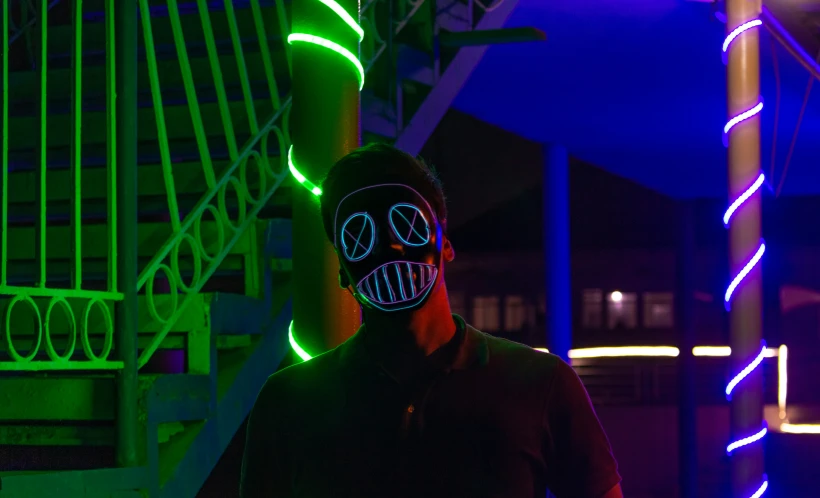 a person wearing a mask and glowing in green