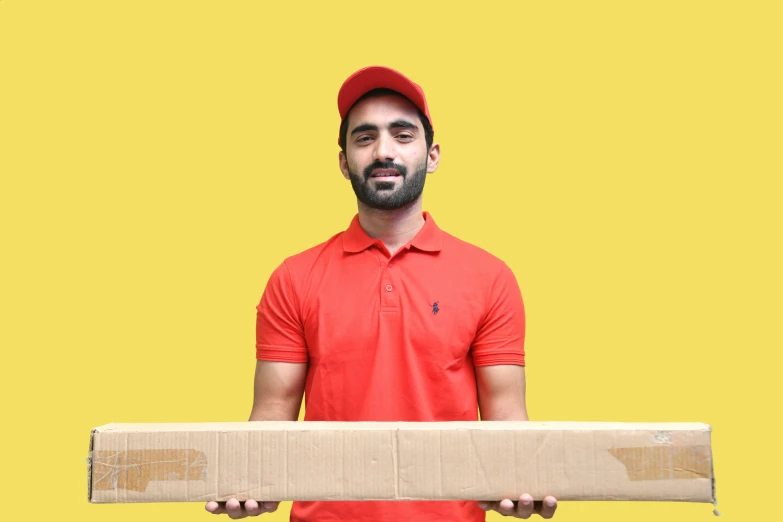 a man holding a box and wearing a red cap