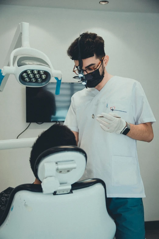 a dentist is examining the teeth of a patient