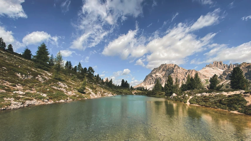 a pond with a mountain in the distance