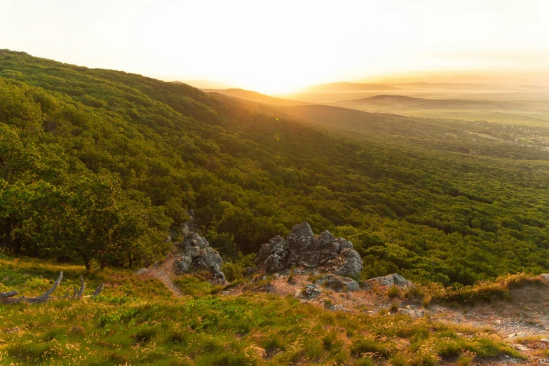 a hill view from top of a mountain in the distance