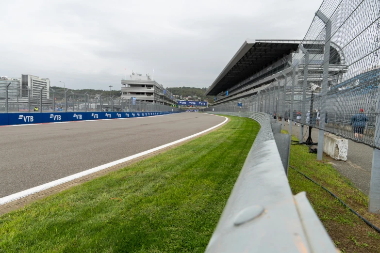 an asphalt race track has grassy short ramps for people to see