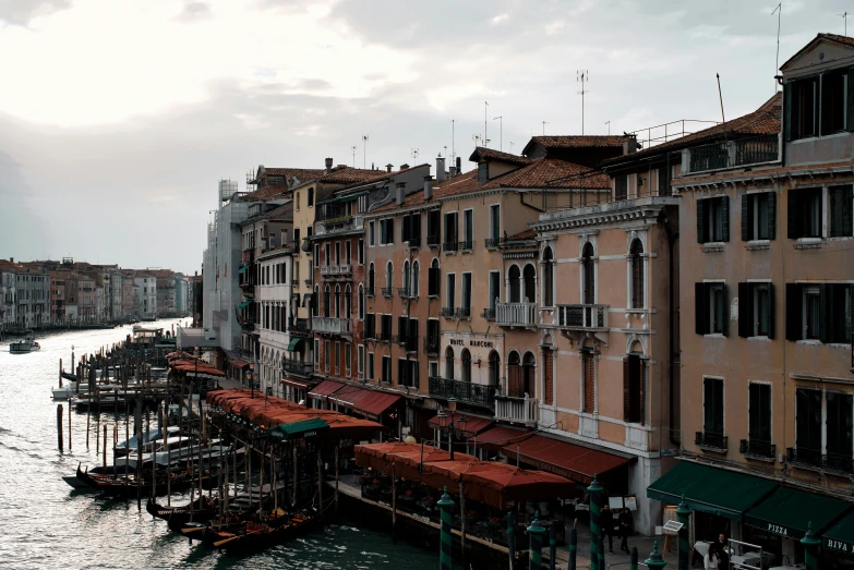 the waterway is lined with old buildings and umbrellas